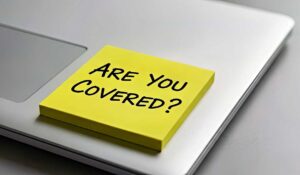 A family reviews health insurance documents beside an insurance card and provider network directory.